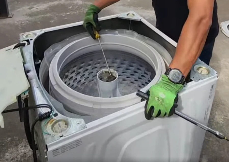 Close-up of a washing machine drum and door filled with water